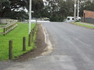 Topsoil and grass removed next to bollards in southern part of Cliff St