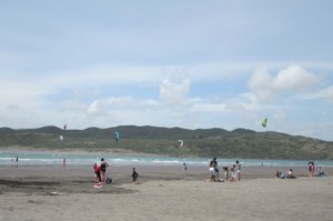 Enjoying the sun and wind on the beach by Raglan's harbour mouth