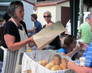 Happy customer buys a loaf of Ruapuke Artisan bread.