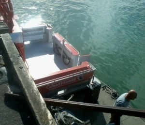 Gallagher Rescue at Raglan Wharf being loaded with Police Dive Team Gear by Raglan Coastguard chief , Wally Hawken.