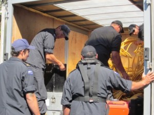 Navy divers unload a truck full of their diving gear at Raglan Wharf on Friday afternoon.