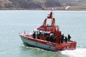 Gallagher Rescue heads out to cross the Raglan bar at 1.50pm today carrying 15 people from the Navy, Civil Aviation Authority and police. Image NZ Police