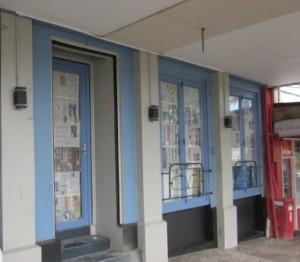 Newspaper covers windows of new liquor store in Bow St