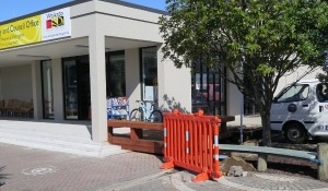 Bike rack and drinking fountain replaced by an orange plastic barrier