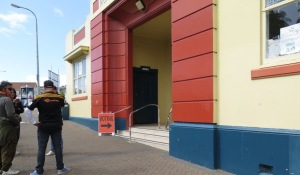 Raglanders discuss the intricacies of voting - outside the Raglan Town Hall on Saturday