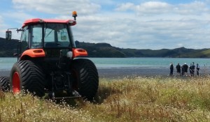 Police stand on the beach  discussing recovery of the plane with tractor at the ready. Image Richard Gallagher