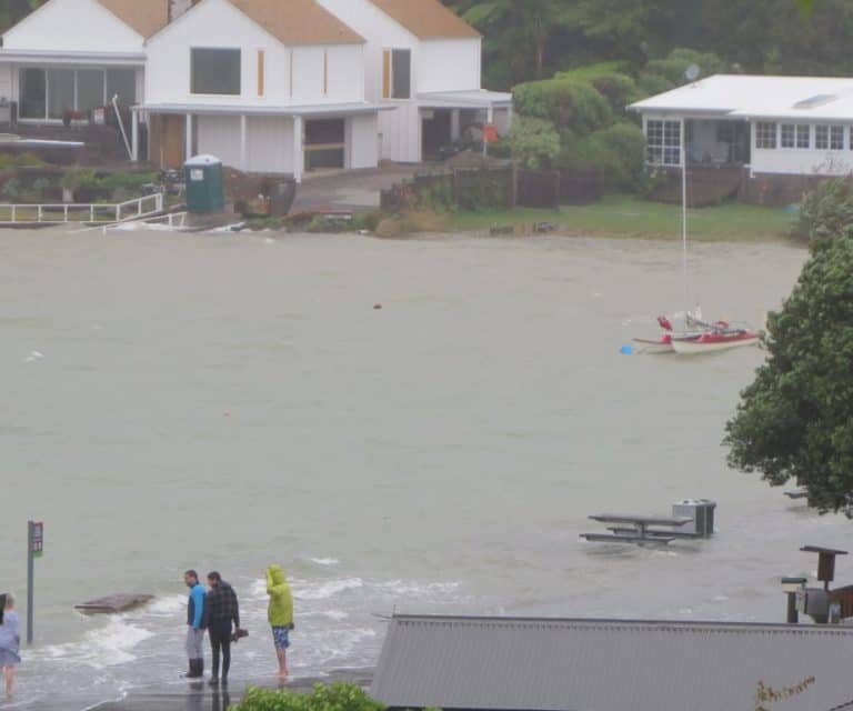 Locals check out the flooding at Lorenzen Bay.